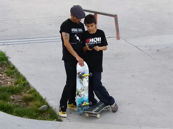 Nate and Skelton reviewing skateboard footage